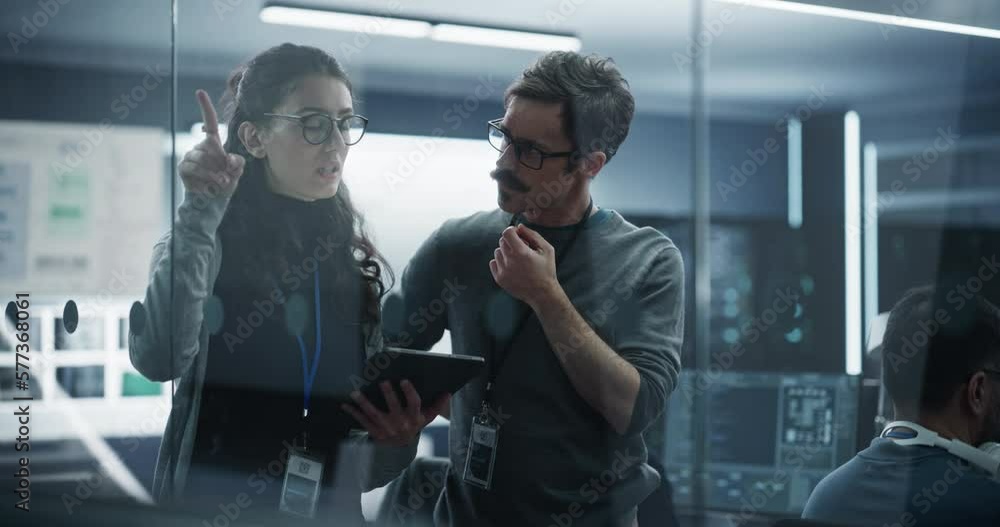 Fototapete Portrait of Two Creative Young Female and Male Engineers Using Tablet Computer to Analyze and Discuss How to Proceed with the Artificial Intelligence Software. Standing in High Tech Research Office