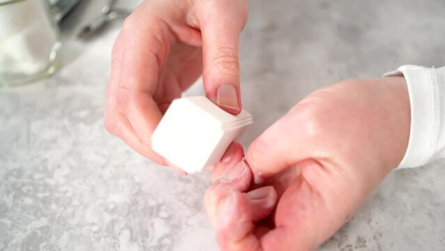 Time lapse. Woman finishing her manicure at home with simple manicure tools. Buffering nails with a nail buffer block.