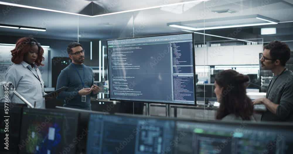 Fototapete Multiethnic QA Engineer Hosts a Team Meeting to Find and Fixes Bugs in a Product or Program Software Code Before the Launch, Collaborating and Talking with Colleagues. Young Specialists at Work