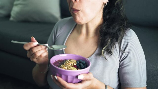 Latin woman lying on the living room healthy breakfast. Healthy lifestyle and well being concept