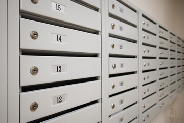 A row of new empty mailboxes with numbers of apartments