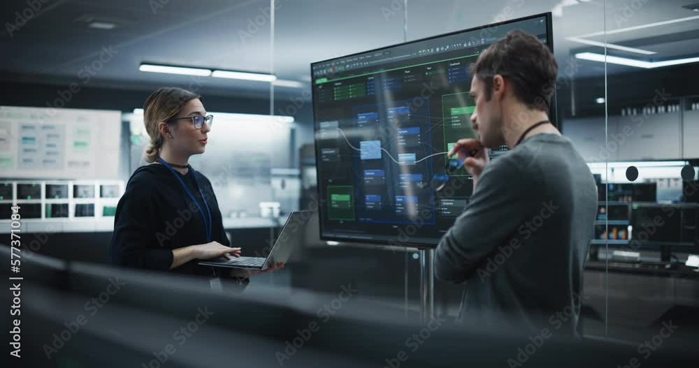 Poster Two Diverse Software Developers Having a Meeting in a Conference Room. Female and Male Tech Industry Engineers Brainstorming Ideas for Their Neural Network Blockchain Startup