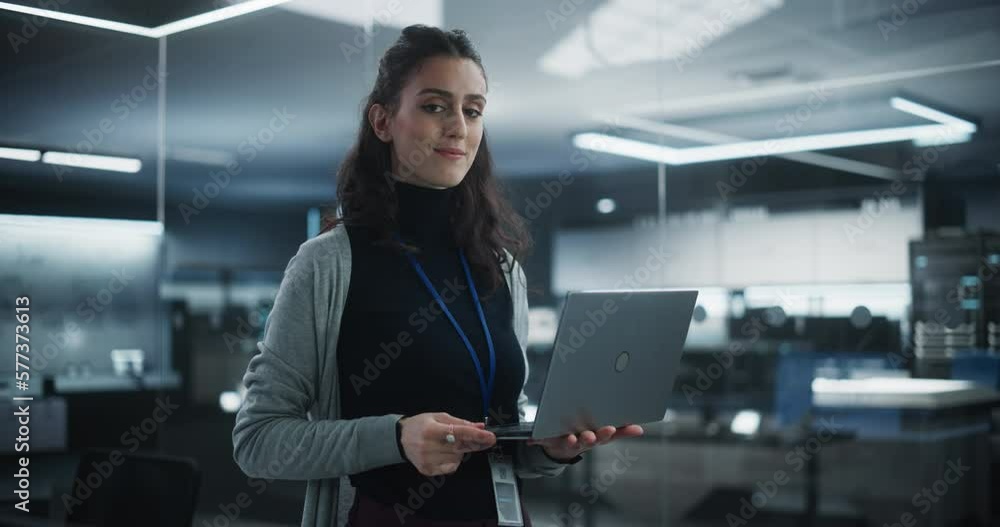Poster Portrait of a Happy Smiling Female, Using Laptop Computer, Looking at Camera and Smiling. Empowered Information Technology Specialist, Software Engineer or Developer