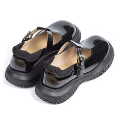 Black shiny glossy comfortable leather women's sandals on a thick rubber sole on a white background