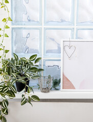 home design interior sofa in living room vase with artifical flowers,palm leaf on wall minimalist,armchair and bedroom with small pillows and blanket,easter decor golden rabbit on table.indoors