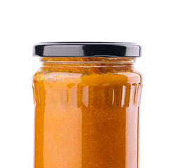 The glass jar with squash caviar on white