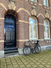 Fototapeta na wymiar bicycle in front of a brick stone house