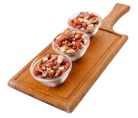 Assorted nuts in a glass bowls on wooden