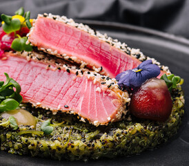 Rare ahi tuna steak slices with fresh herbs