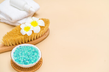 Obraz na płótnie Canvas Beauty treatment items for spa procedures on beigh table. Massage brush, sea salt. copy space