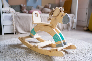 Fototapeta na wymiar Toys for children wooden horse swing, handmade.