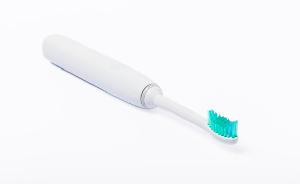 Electronic ultrasonic toothbrush on charging stand isolated on white background. Dental concept. Oral care. Caries prevention.