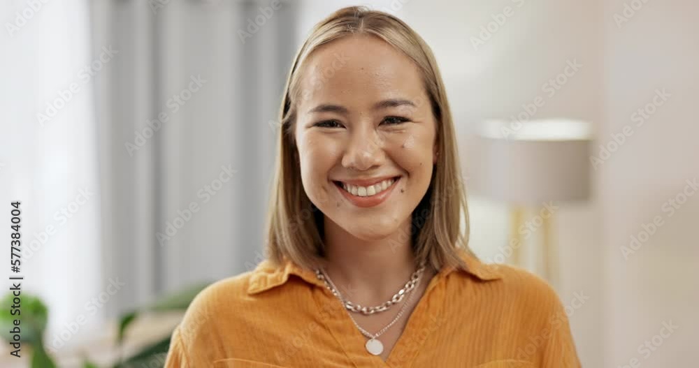 Wall mural Face, smile and happy Asian woman in home, smiling and enjoying free time. Beauty portrait, joy emoji and excited, young and cheerful confident female from Japan relaxing in house and having fun.