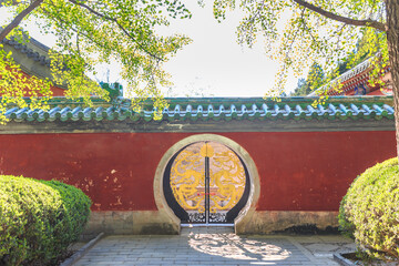 Beijing Ritan Park in spring, red walls and moon gate