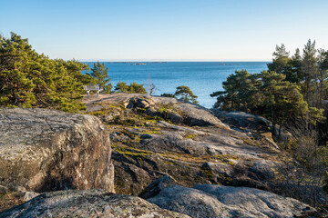 Fototapeta na wymiar View of the rocky shore of Puistovuori in winter, Hanko, Finland