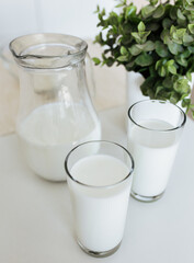 milk in a glass on a white table