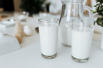 milk in a glass on a white table