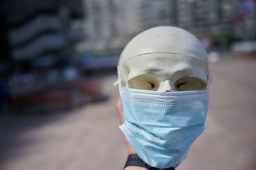 educational medical object human skull in a protective mask