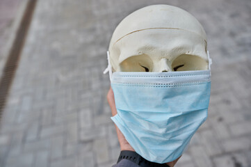 educational medical object human skull in a protective mask