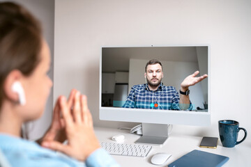 Woman video blogger interviewing a man via online video call.