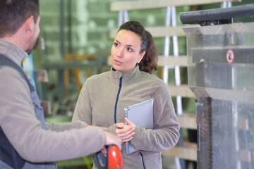 female manager talking to assistant manager in modern factory