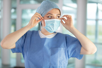 doctor  nurse smiling behind surgeon mask