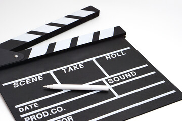 Clapperboard or movie slate black color and marker pen on white background. Cinema industry, video production and film concept.