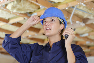 worried woman builder using walkie talkie