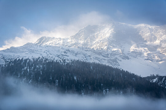 Mountain range in the European Alps in the morning fog