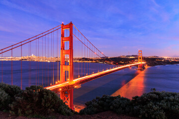 Fototapeta na wymiar Car lights blur over Golden Gate Bridge and San Francisco lit at night