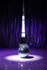 Disco ball on a shiny background. Filled with purple light
