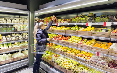 Woman buying fruits and vegetables at the market