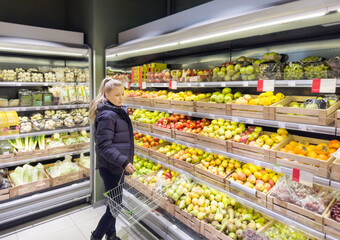 Woman buying fruits and vegetables at the market