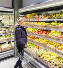 Woman buying fruits and vegetables at the market