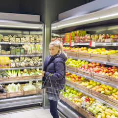 Woman buying fruits and vegetables at the market