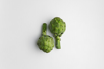 Obraz premium Organic artichokes on the white background