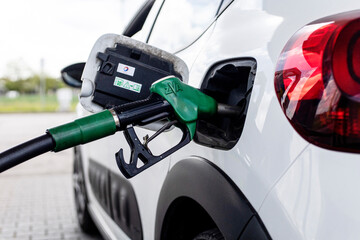 a car fills up at the gas station