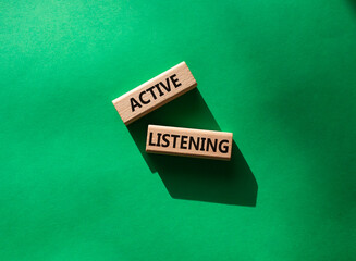 Active listening symbol. Wooden blocks with words Active listening. Beautiful green background. Business and Active listening concept. Copy space.