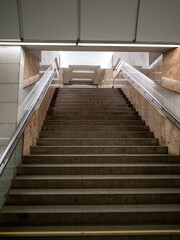 bottom view of stairs in underground passage in subway