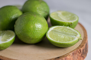 Natural fresh lime with water drops and sliced, green leaf isolated on background, Fresh green lime pile in the harvest season, Juicy slice of lime isolated on background