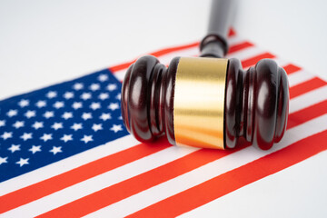 Gavel for judge lawyer and US dollar banknotes on USA America flag, finance concept.