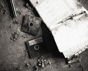 Dirty and obsolete floppy disks and folder on the ground