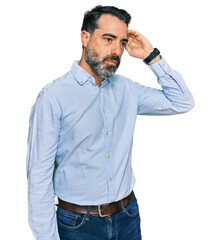 Middle aged man with beard wearing business shirt confuse and wondering about question. uncertain...
