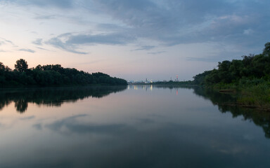 Landscape of Sava river and oil refinery at dusk, petrochemical industry