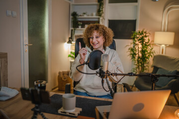 woman shooting or streaming video podcast or vlogg blogger at studio