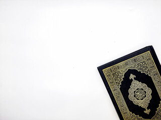 Ramadan Kareem, Eid Mubarak or Islamic concept. The Islamic holy book, Quran or Kuran, on grey background. Arabic words on the book means "Holy Quran". Top view Copy space
