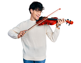 Handsome hipster young man playing violin smiling and laughing hard out loud because funny crazy joke. © Krakenimages.com