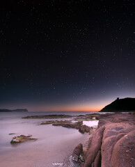 Quiet bay at night under the stars. Porto Ferro, Sardinia. Italy