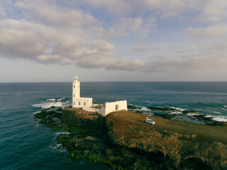 Fototapeta na wymiar Aerial photos of Farol da Praia in Santiago, Cape Verde showcase a stunning lighthouse on a rugged coastline with breathtaking views of the Atlantic Ocean, surrounded by dramatic cliffs, sandy beaches