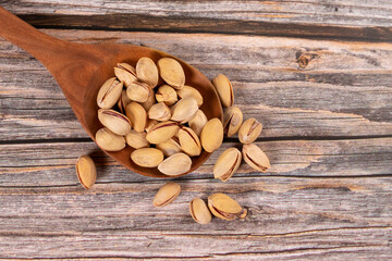 Pistachios on wooden spoon